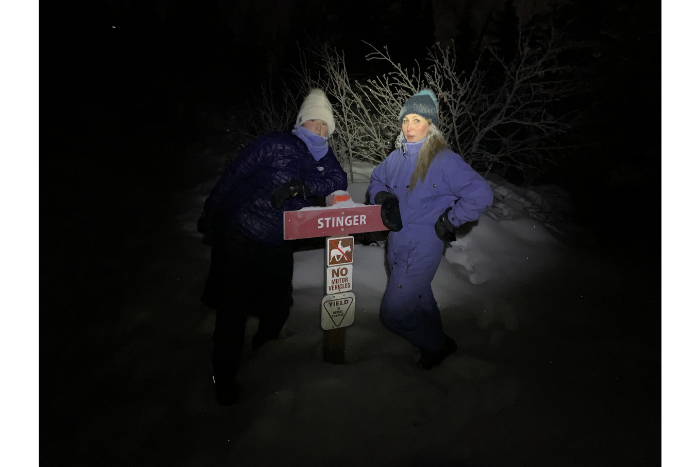 two women standing in dark